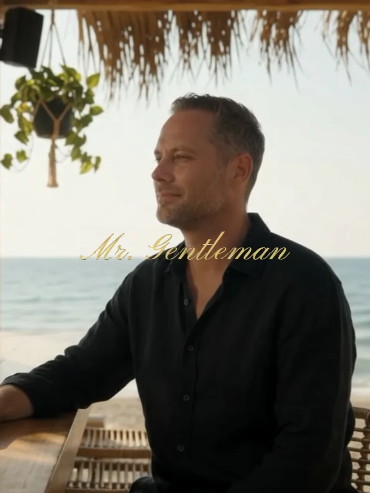 Mr. Gentleman in a black shirt looking out to sea from a beach taverna in Plakias, Crete
