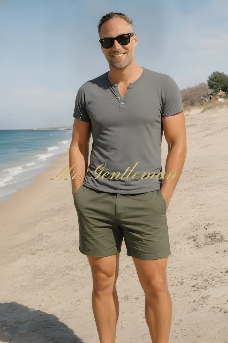 Mr. Gentleman in a grey henley on a sunny beach in Bali, Crete